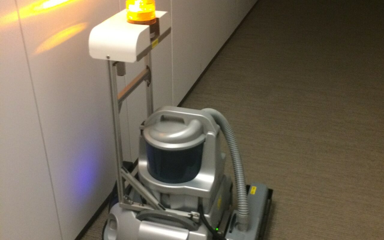 Un aspirateur robot en fonctionnement sur un sol clair