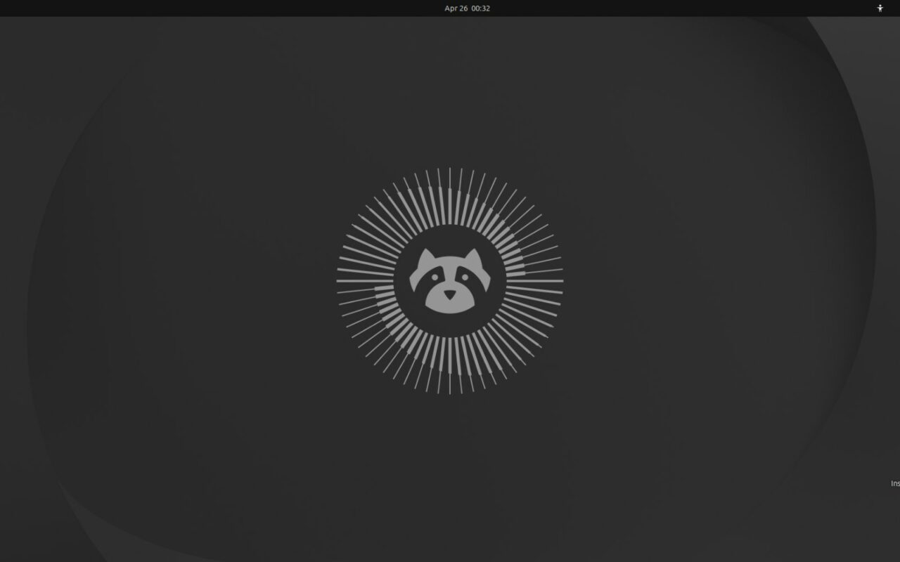 Capture du bureau d'Ubuntu 26.04 LTS en thème sombre, avec au centre la mascotte raton laveur de la version Resolute Raccoon