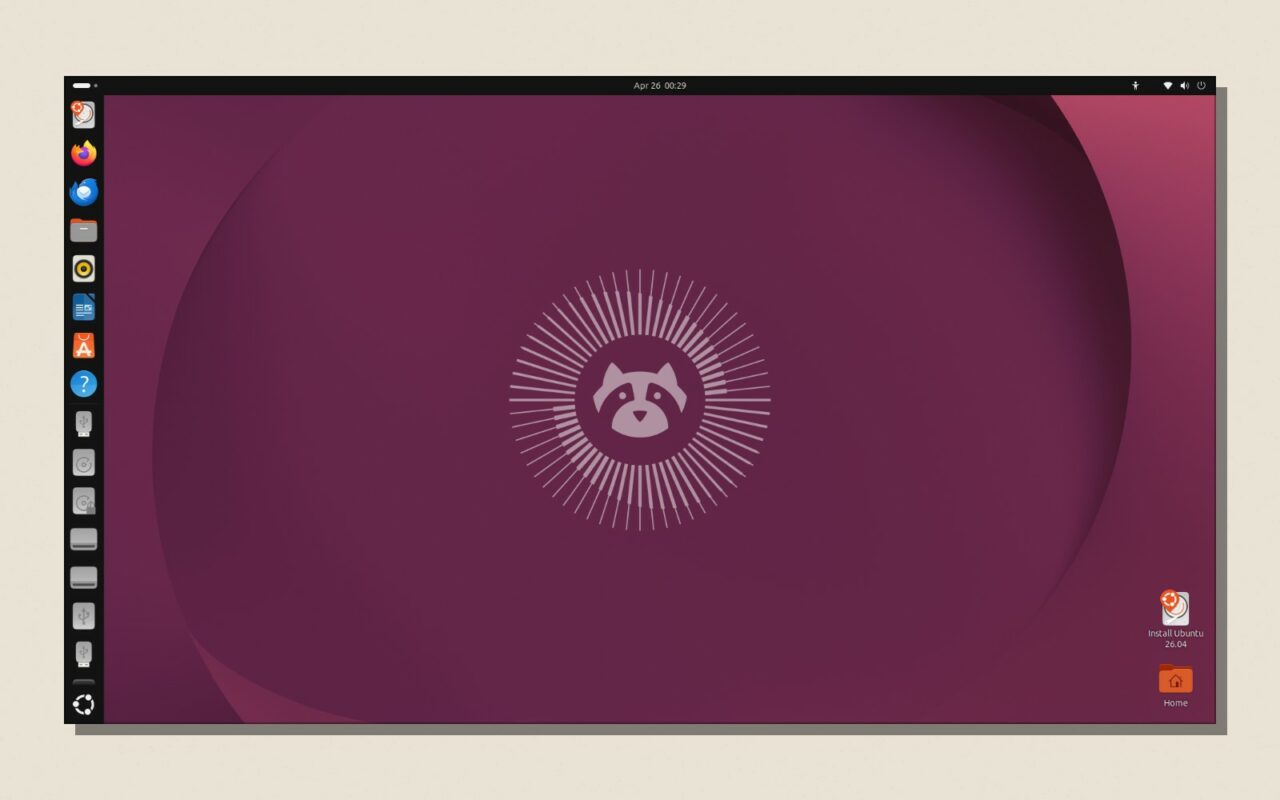 Capture du bureau GNOME d Ubuntu 26.04 LTS, posee sur un fond papier avec une ombre portee