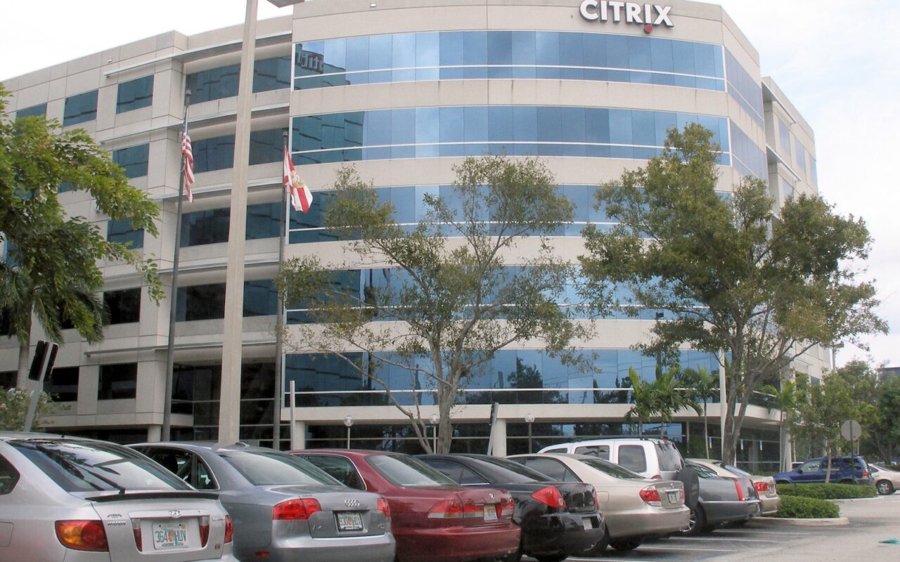 Immeuble de bureaux vitré du siège de Citrix à Fort Lauderdale, avec des voitures garées devant